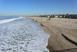 A beach off the coast of San Diego, California; The Hollywood sign is visible from the mountains here at certain angles